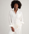 Model is wearing UNTUCKit Wrinkle-Resistant Linen Relaxed Fit Melanie Shirt in white. 