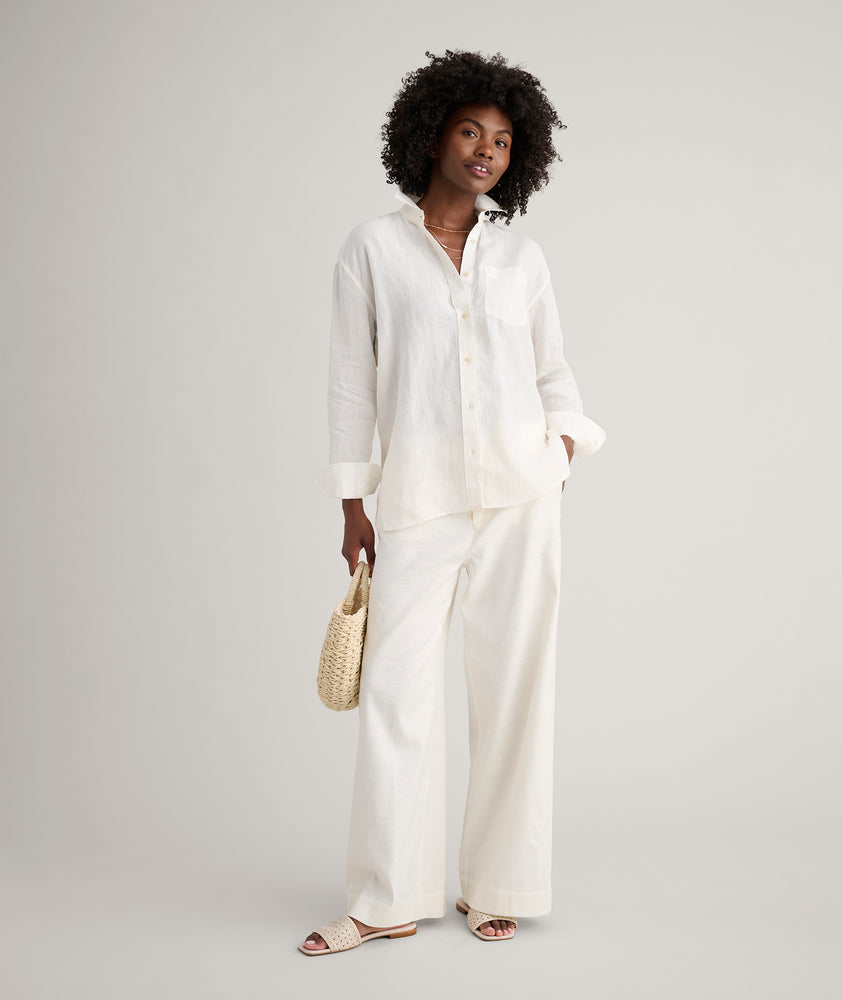Model is wearing UNTUCKit Wrinkle-Resistant Linen Relaxed Fit Melanie Shirt in white. 