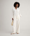 Model is wearing UNTUCKit Wrinkle-Resistant Linen Relaxed Fit Melanie Shirt in white. 