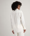 Model is wearing UNTUCKit Wrinkle-Resistant Linen Relaxed Fit Melanie Shirt in white. 