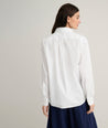 Model is wearing UNTUCKit Melanie shirt in White.