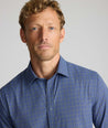 Model wearing a blue check UNTUCKit Performance Shirt.