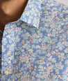 Model is wearing UNTUCKit Meriwether short sleeve in green, blu and yellow print. 