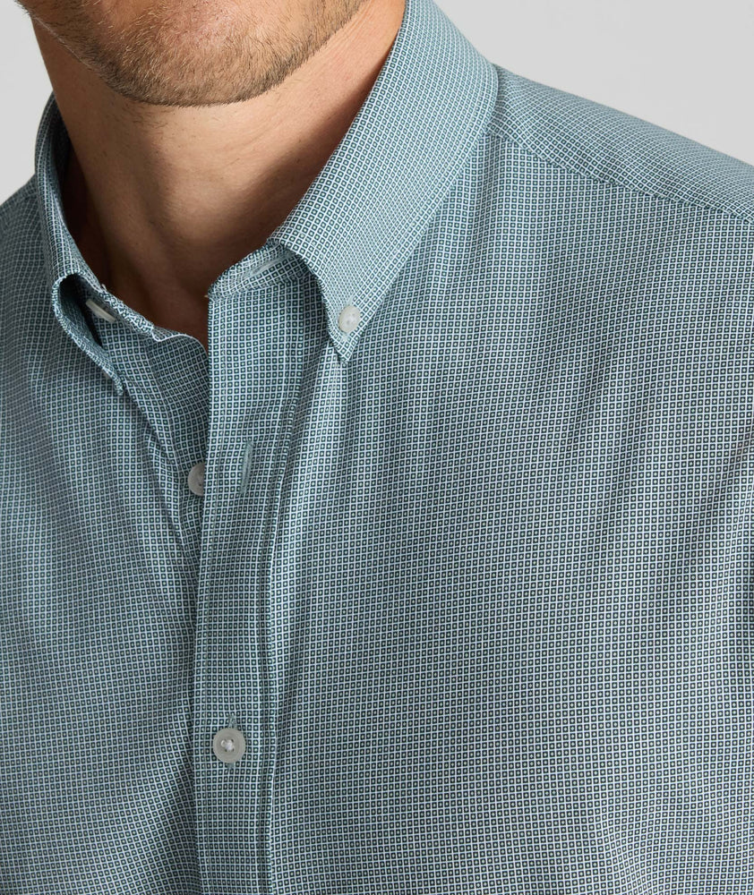 Model is wearing UNTUCKit Performance Milford Shirt in green print.