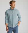Model is wearing UNTUCKit Performance Milford Shirt in green print.