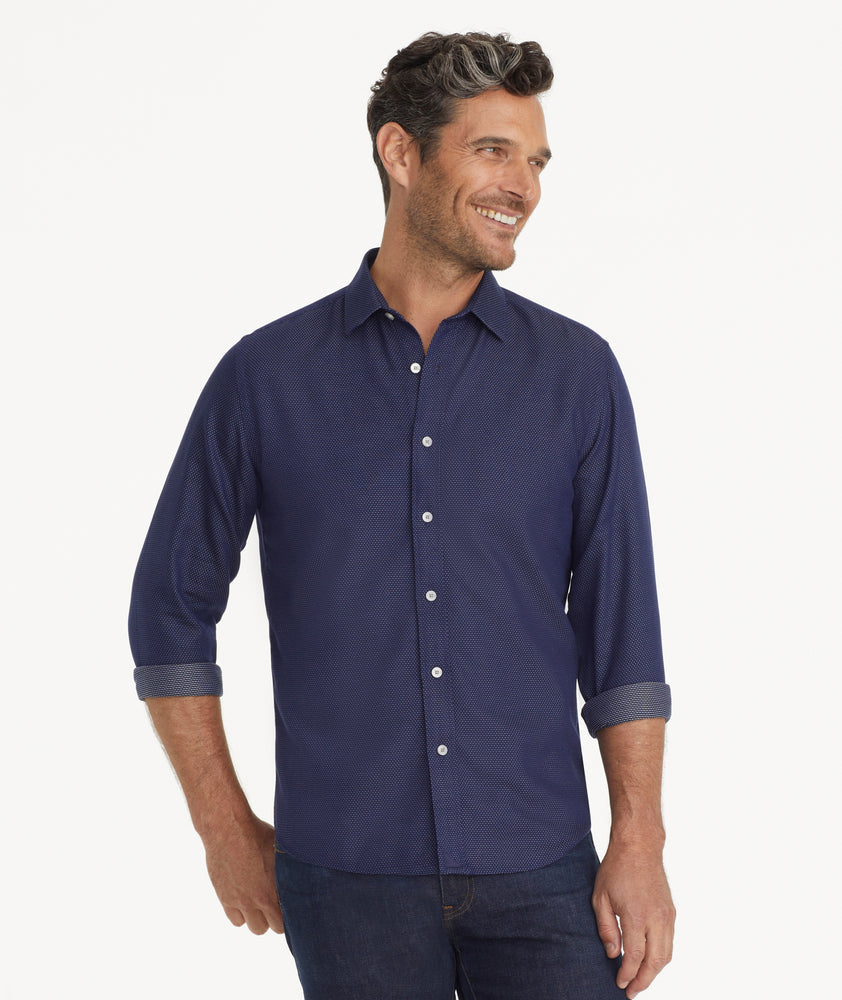 Model is wearing UNTUCKit Wrinkle-Free Milo Shirt in Navy & White Print