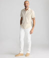 Model is wearing UNTUCKit Stretch Cotton Hybrid Pant in Cream. 