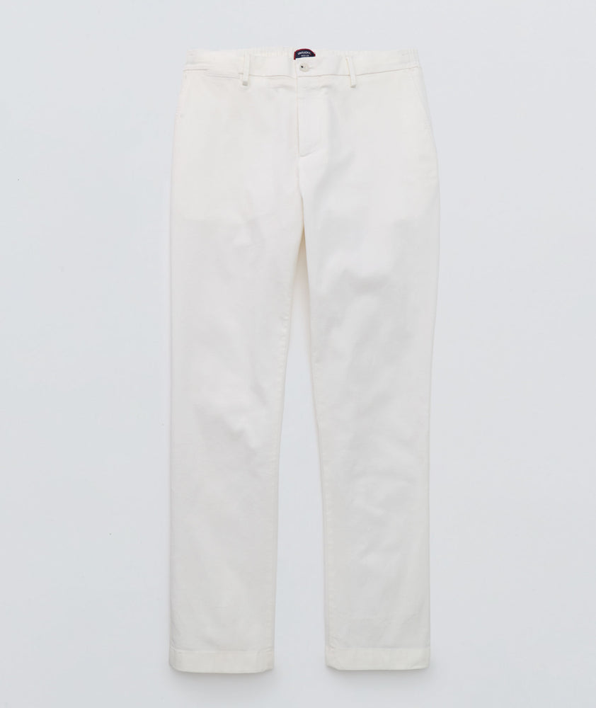 Model is wearing UNTUCKit Stretch Cotton Hybrid Pant in Cream. 