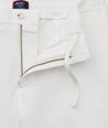 Model is wearing UNTUCKit Stretch Cotton Hybrid Pant in Cream. 
