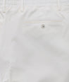 Model is wearing UNTUCKit Stretch Cotton Hybrid Pant in Cream. 