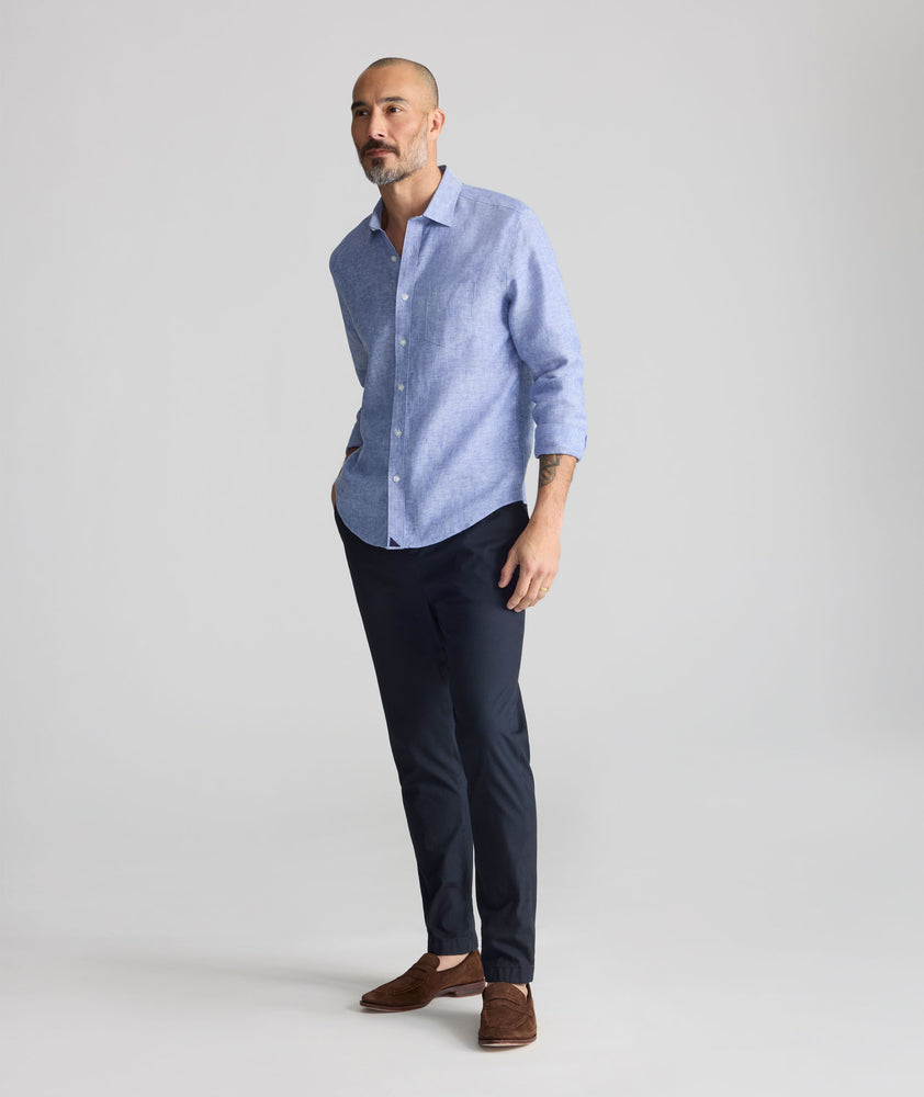 Model is wearing UNTUCKit Stretch Cotton Hybrid Pants in Navy.