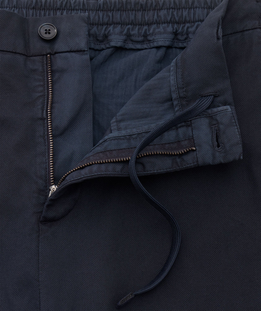 Model is wearing UNTUCKit Stretch Cotton Hybrid Pants in Navy.