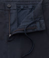 Model is wearing UNTUCKit Stretch Cotton Hybrid Pants in Navy.