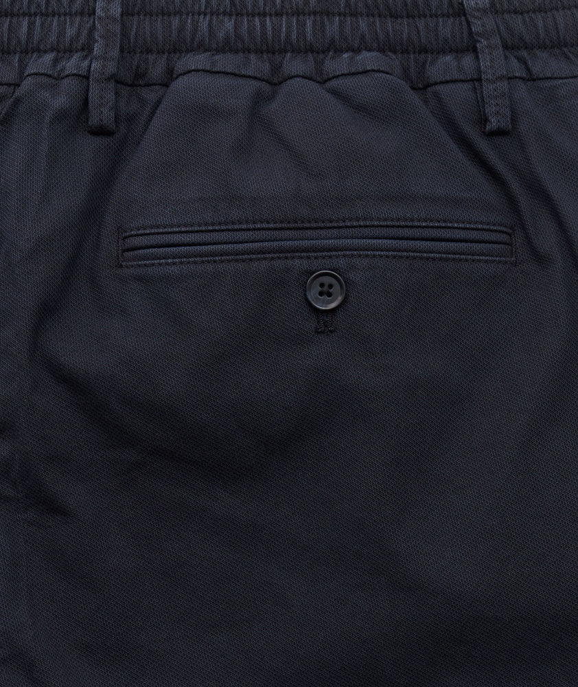 Model is wearing UNTUCKit Stretch Cotton Hybrid Pants in Navy.
