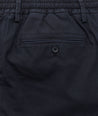 Model is wearing UNTUCKit Stretch Cotton Hybrid Pants in Navy.