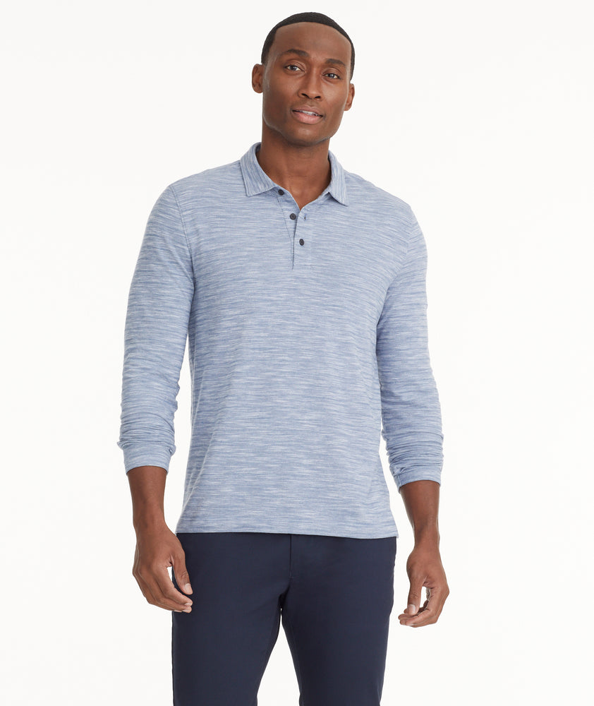 Model is wearing UNTUCKit Marled Long-Sleeve Polo in Navy.