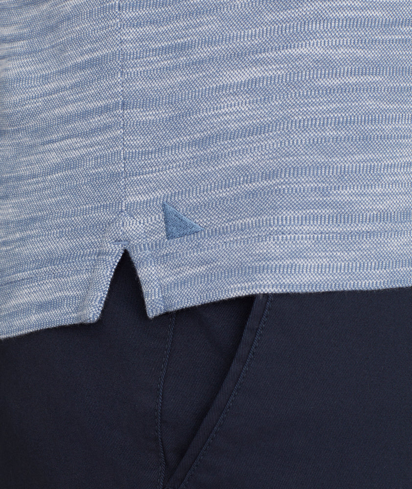 Model is wearing UNTUCKit Marled Long-Sleeve Polo in Navy.