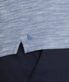 Model is wearing UNTUCKit Marled Long-Sleeve Polo in Navy.
