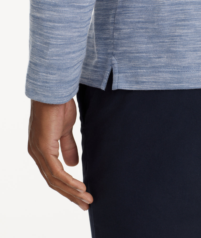Model is wearing UNTUCKit Marled Long-Sleeve Polo in Navy.