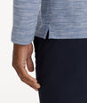 Model is wearing UNTUCKit Marled Long-Sleeve Polo in Navy.