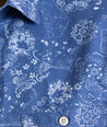 Model is wearing UNTUCKit Monroe cotton linen short sleeve shirt in blue print. 
