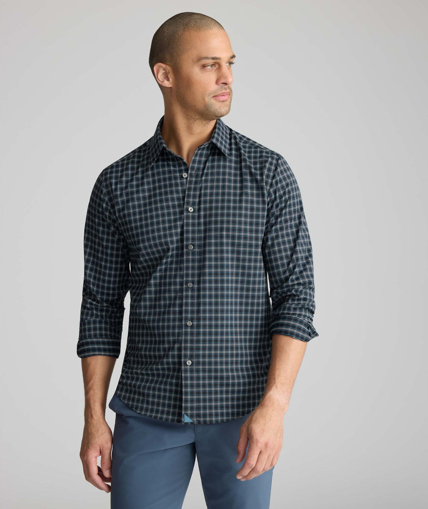 Model is wearing UNTUCKit Performance Monteluce Shirt in black check. 