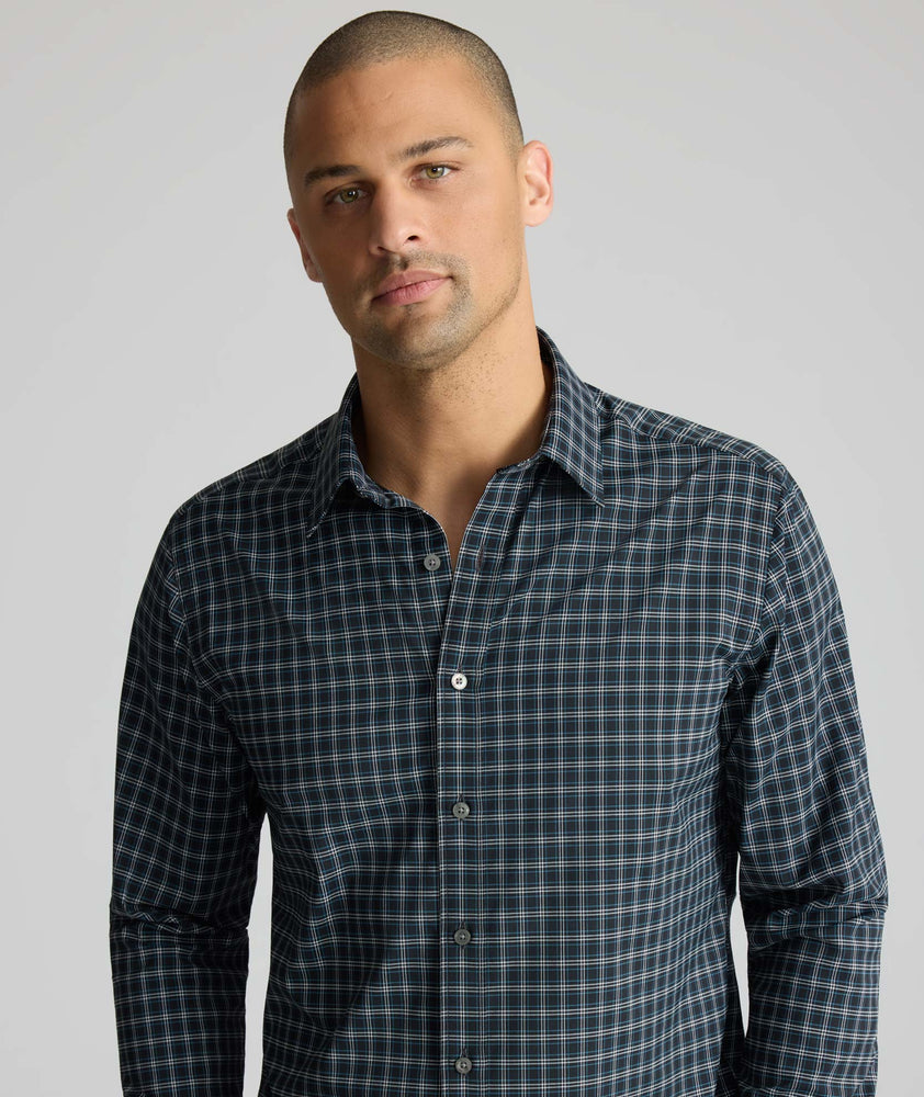 Model is wearing UNTUCKit Performance Monteluce Shirt in black check. 