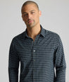 Model is wearing UNTUCKit Performance Monteluce Shirt in black check. 
