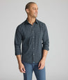 Model is wearing UNTUCKit Performance Monteluce Shirt in black check. 