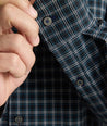 Model is wearing UNTUCKit Performance Monteluce Shirt in black check. 