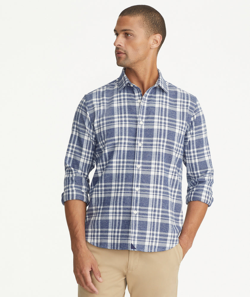 Model is wearing UNTUCKit Flannel Morenillo Shirt in Heathered Blue Plaid