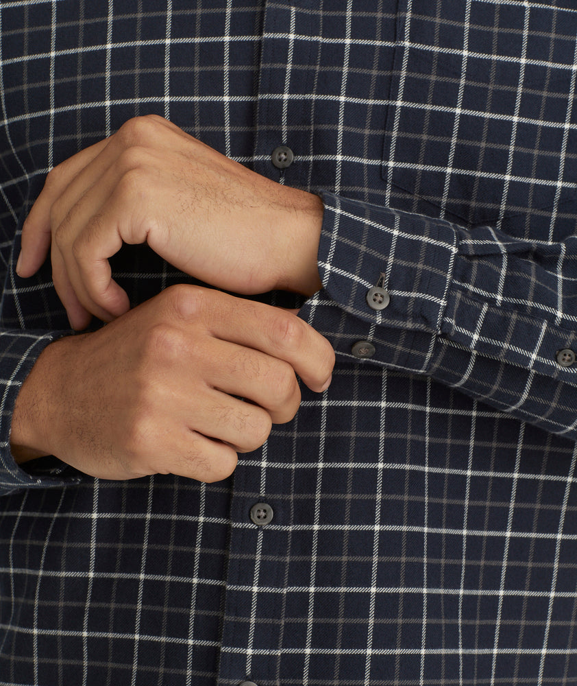 Model is wearing UNTUCKit Flannel Morisco Shirt in Navy & White Windowpane Check