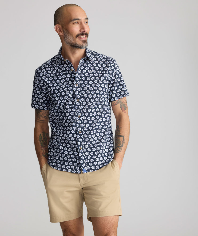 Model is wearing UNTUCKit Vintage Wash Short-Sleeve Morningside Shirt	in Navy Flower Print.
