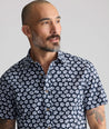 Model is wearing UNTUCKit Vintage Wash Short-Sleeve Morningside Shirt	in Navy Flower Print.