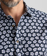Model is wearing UNTUCKit Vintage Wash Short-Sleeve Morningside Shirt	in Navy Flower Print.