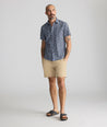 Model is wearing UNTUCKit Vintage Wash Short-Sleeve Morningside Shirt	in Navy Flower Print.