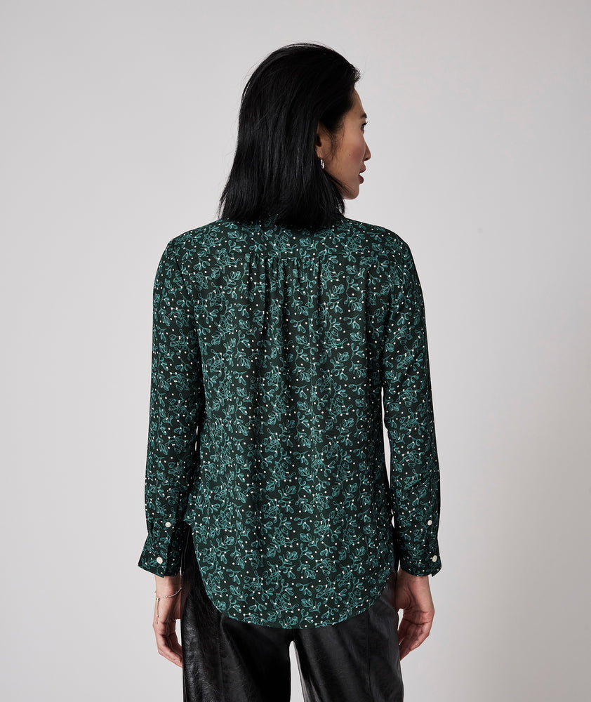 Model is wearing UNTUCKit Natalie top in green.