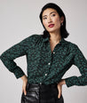 Model is wearing UNTUCKit Natalie top in green.