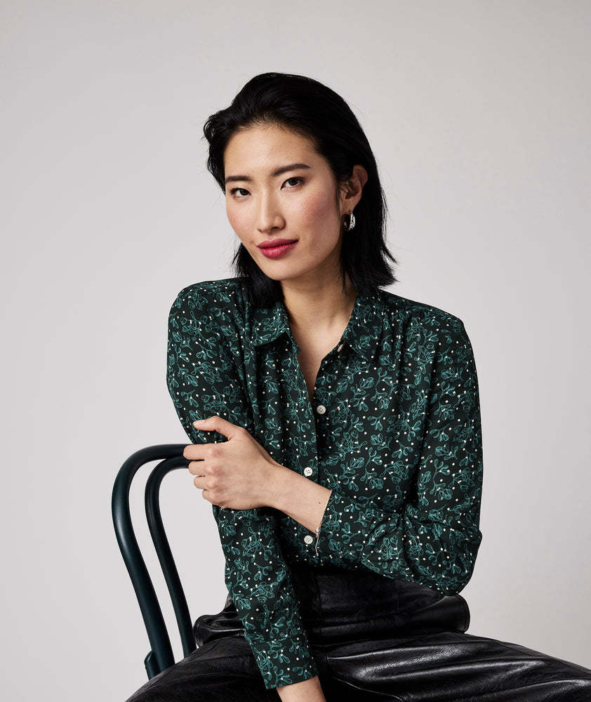 Model is wearing UNTUCKit Natalie top in green.
