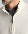Model is wearing UNTUCKit Cotton Quarter-Zip Sweater in cream.