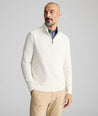 Model is wearing UNTUCKit Cotton Quarter-Zip Sweater in cream.