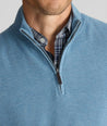 Model is wearing UNTUCKit Cotton Quarter-Zip Sweater in light blue. 