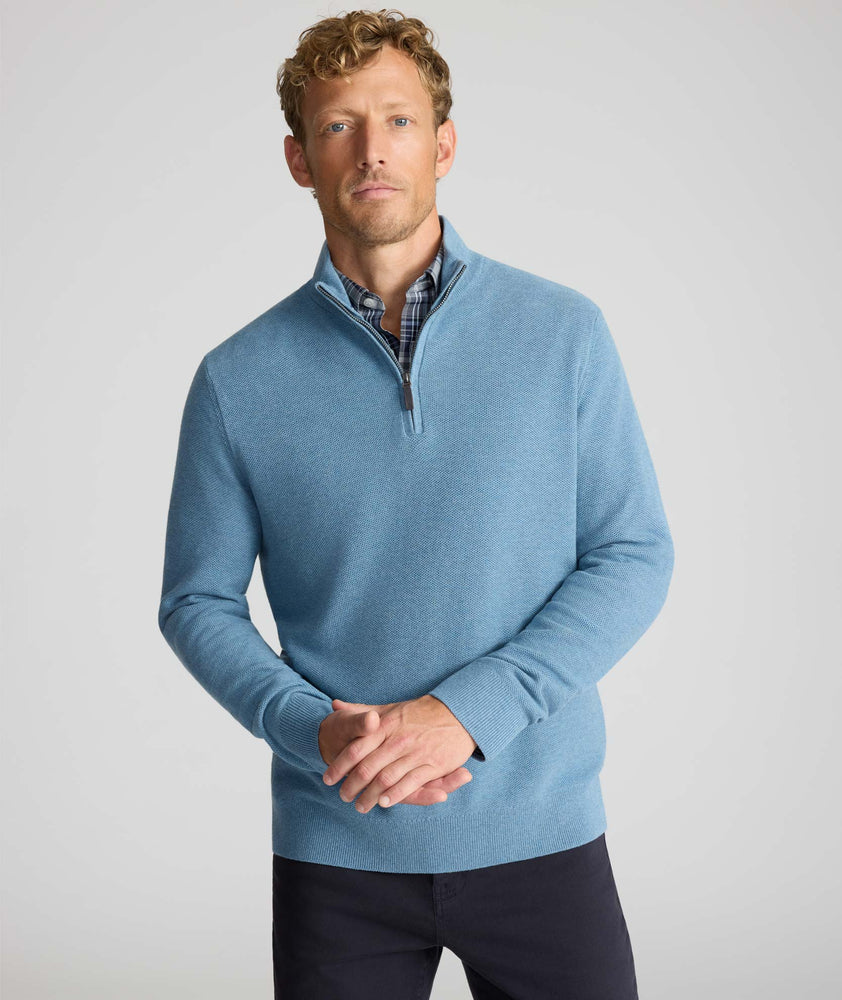 Model is wearing UNTUCKit Cotton Quarter-Zip Sweater in light blue. 