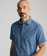 Model is wearing UNTUCKit Vintage Wash Short-Sleeve Normand Shirt in navy. 