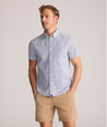 Model is wearing UNTUCKit Performance Short-Sleeve Nouveau Shirt in Navy Geo Print.