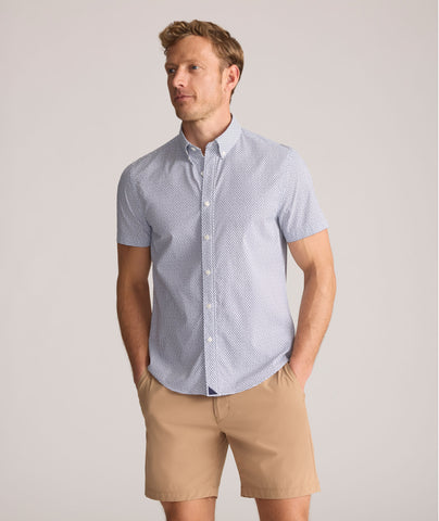 Model is wearing UNTUCKit Performance Short-Sleeve Nouveau Shirt in Navy Geo Print.