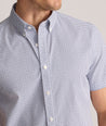 Model is wearing UNTUCKit Performance Short-Sleeve Nouveau Shirt in Navy Geo Print.