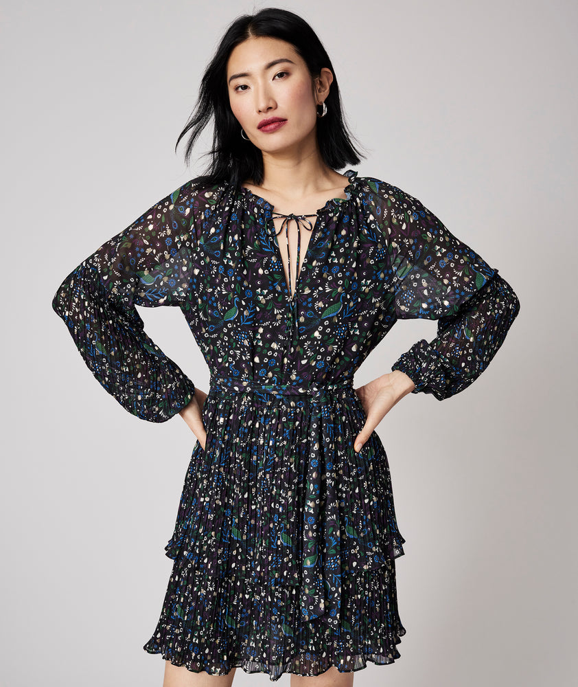 Model is wearing UNTUCKit Paloma dress in black print.