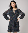 Model is wearing UNTUCKit Paloma dress in black print.
