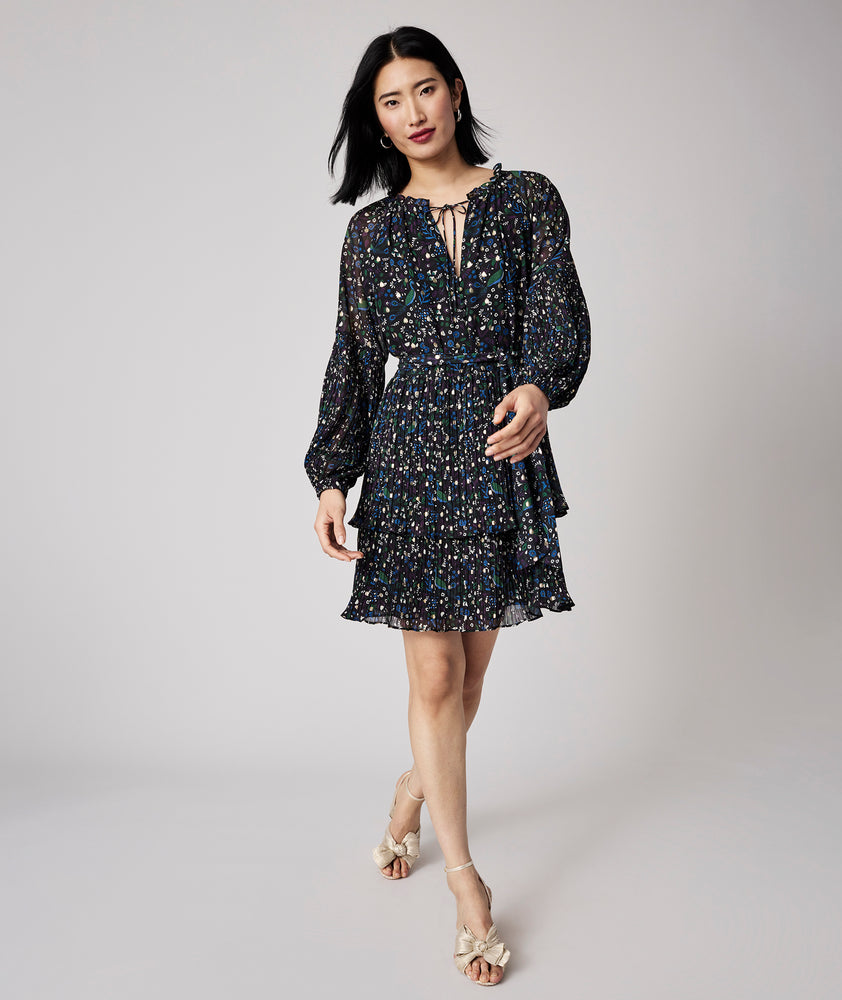 Model is wearing UNTUCKit Paloma dress in black print. 